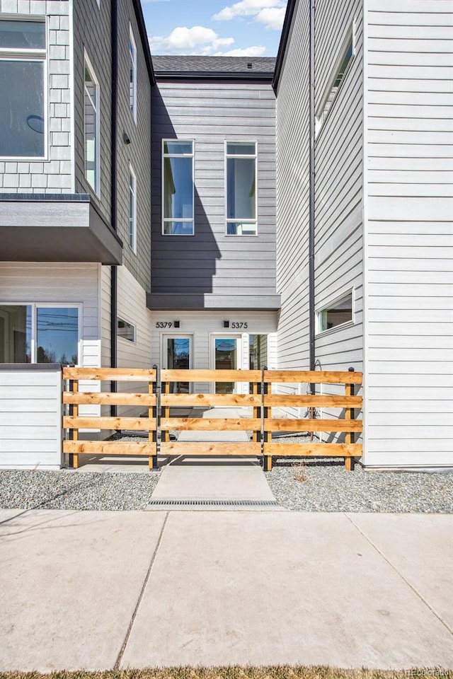 view of property exterior featuring a fenced front yard and a gate