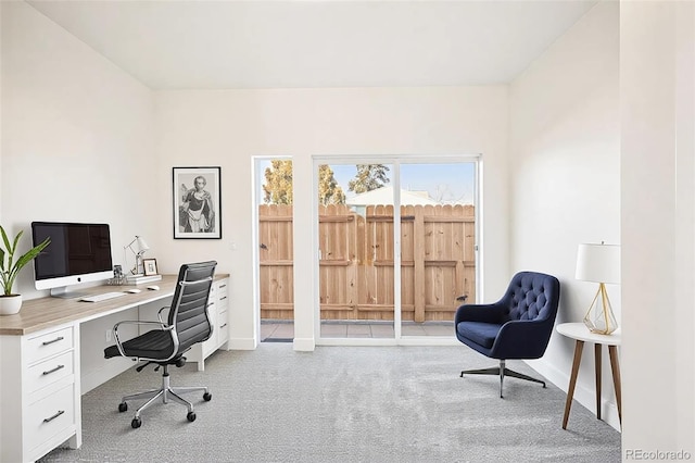 office with baseboards and light colored carpet