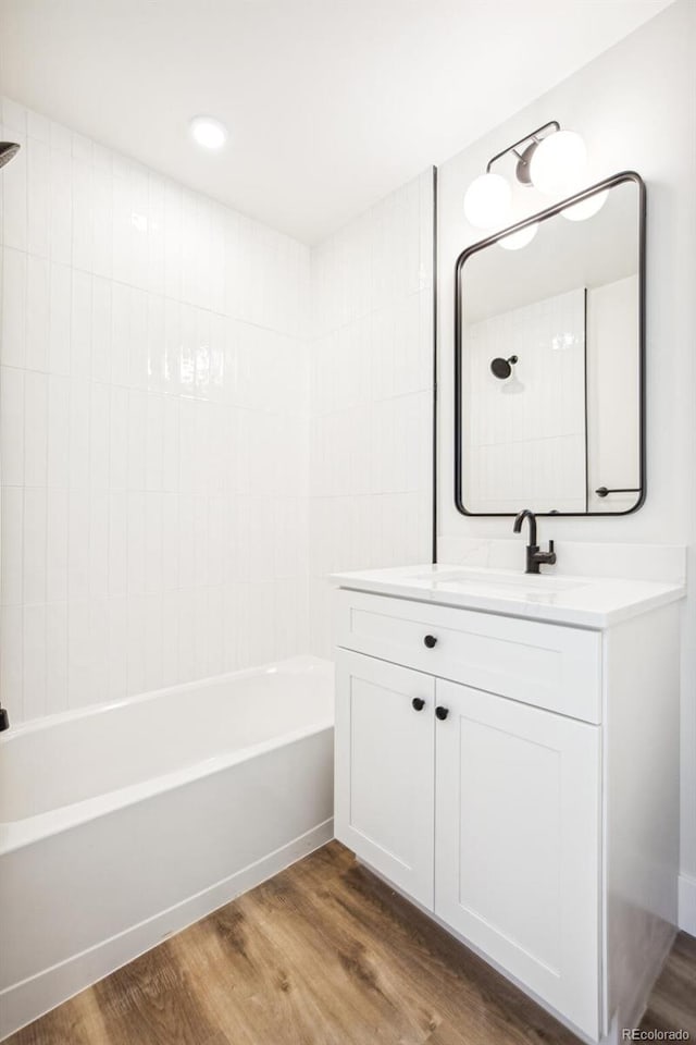 bathroom with vanity, shower / bathtub combination, and wood finished floors