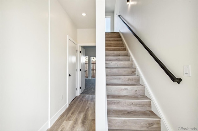 stairs featuring recessed lighting, baseboards, and wood finished floors