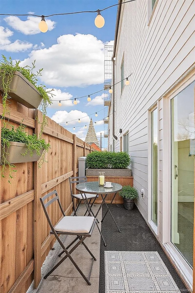 view of patio featuring fence