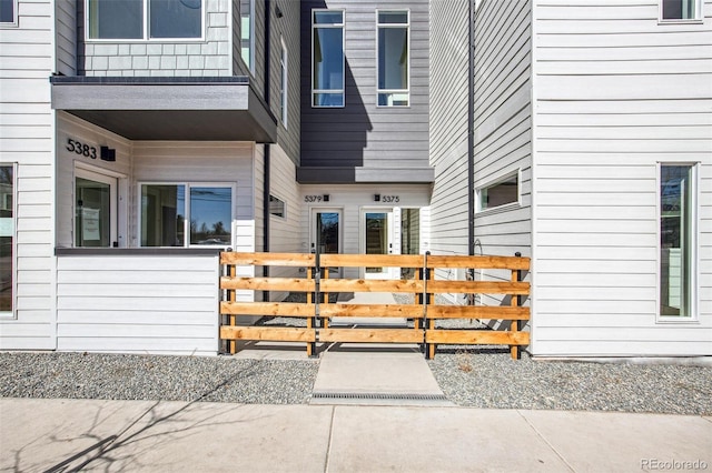 doorway to property featuring fence