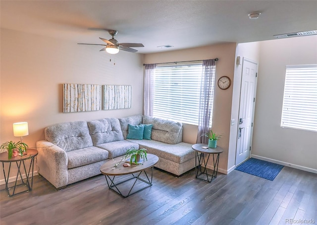 living room featuring ceiling fan and dark hardwood / wood-style flooring