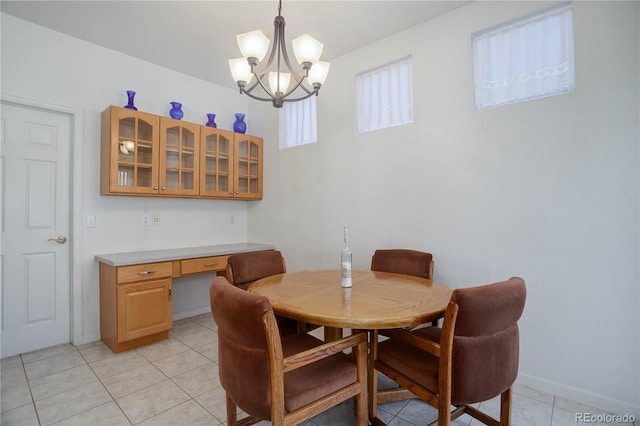2608 S Troy Ct, Aurora, CO 80014 - dining area featuring a chandelier, light tile patterned floors, and baseboards