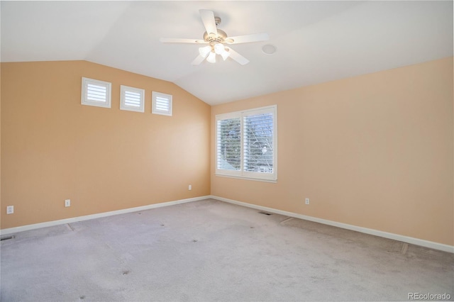 2608 S Troy Ct, Aurora, CO 80014 - spare room with vaulted ceiling, ceiling fan, light carpet, and baseboards