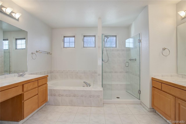 2608 S Troy Ct, Aurora, CO 80014 - bathroom featuring healthy amount of natural light, a shower stall, a garden tub, and two vanities