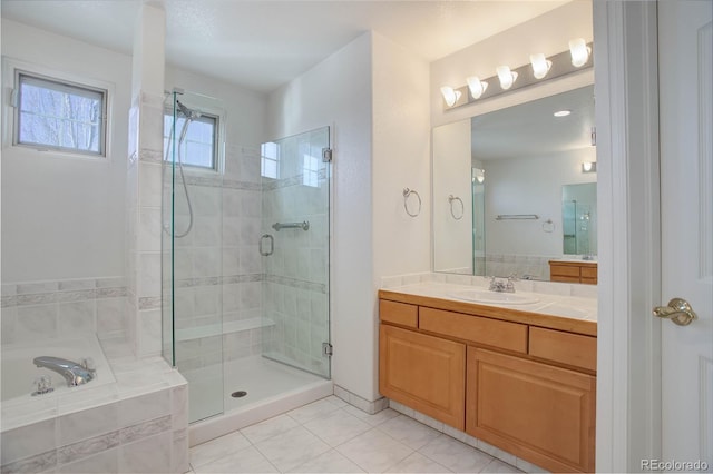 2608 S Troy Ct, Aurora, CO 80014 - bathroom featuring a shower stall, a garden tub, vanity, and tile patterned floors