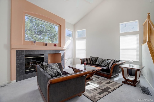 2608 S Troy Ct, Aurora, CO 80014 - living area with carpet, a fireplace, high vaulted ceiling, baseboards, and healthy amount of natural light