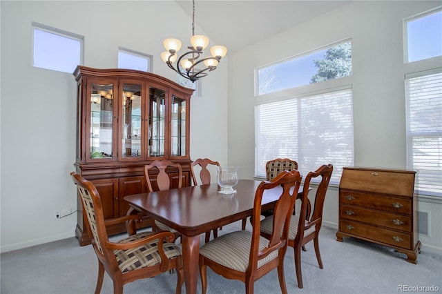 2608 S Troy Ct, Aurora, CO 80014 - dining room with a towering ceiling, light colored carpet, a chandelier, and healthy amount of natural light