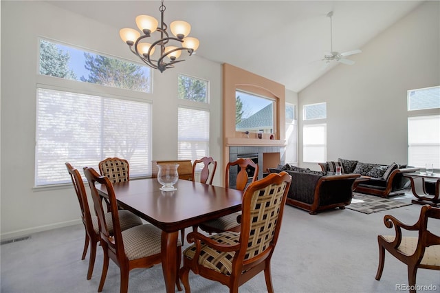 2608 S Troy Ct, Aurora, CO 80014 - dining room with plenty of natural light, light carpet, a chandelier, a ceiling fan, and high vaulted ceiling