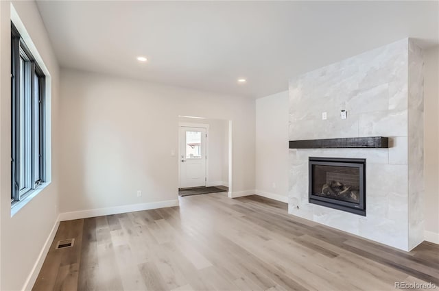 1103 Lupine Ln, Tabernash, CO 80478 - unfurnished living room with a tile fireplace, wood finished floors, baseboards, visible vents, and recessed lighting