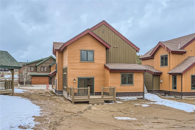1103 Lupine Ln, Tabernash, CO 80478 - snow covered house featuring a shingled roof, a wooden deck, and board and batten siding