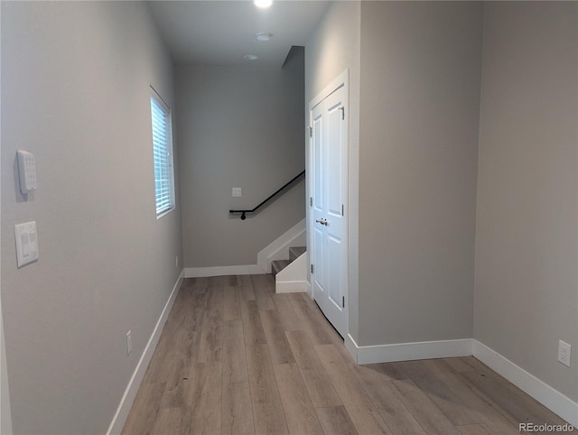 corridor with light hardwood / wood-style flooring