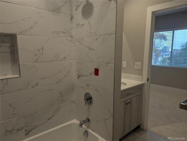 bathroom featuring vanity and tiled shower / bath