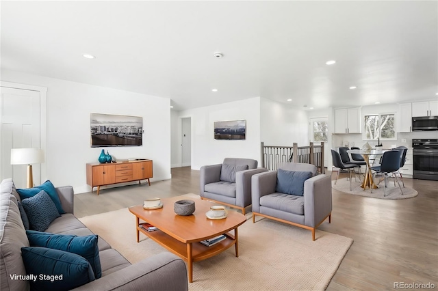 living room featuring light wood-type flooring and recessed lighting