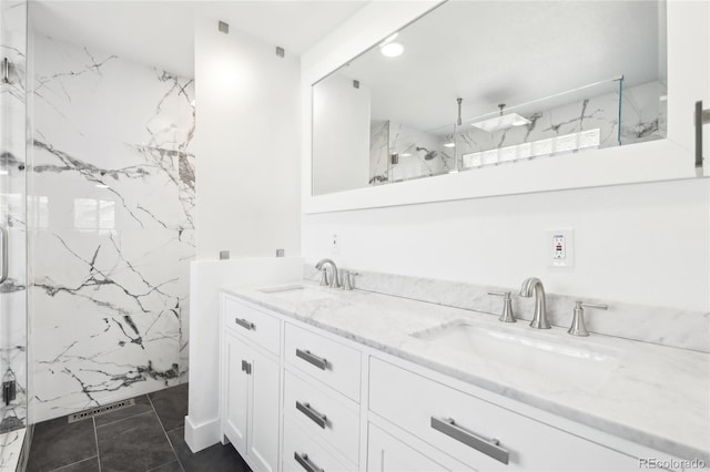 full bath featuring visible vents, double vanity, a sink, and a marble finish shower