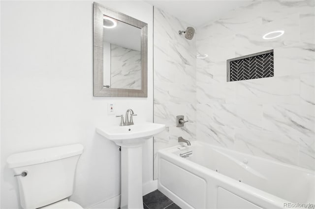 full bath featuring a sink, bathtub / shower combination, and toilet