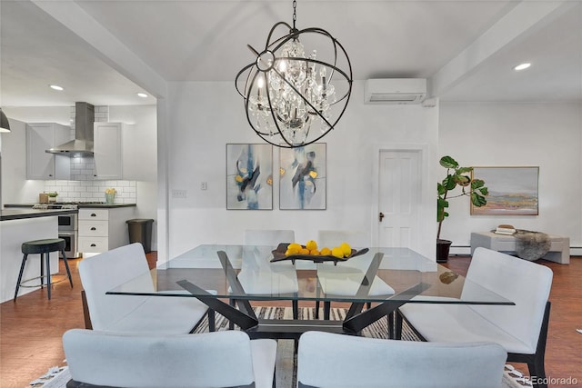 dining space with a notable chandelier, an AC wall unit, and hardwood / wood-style floors