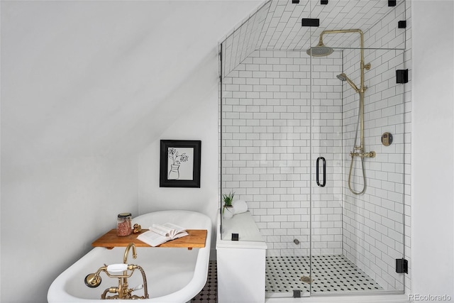 bathroom featuring vaulted ceiling and a shower with shower door