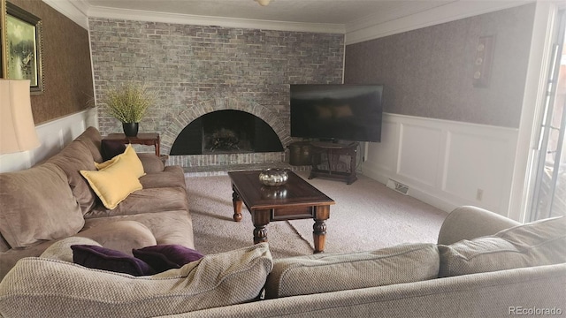living area with carpet, visible vents, crown molding, a wainscoted wall, and a fireplace