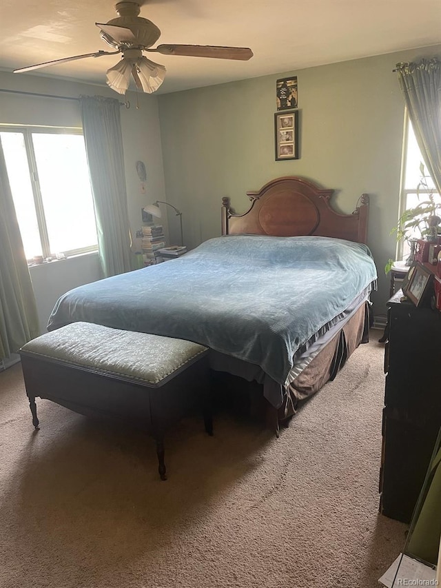 bedroom with ceiling fan and carpet