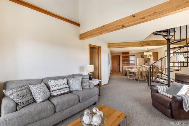 9430 Ryan Gulch Rd Unit 9450, Silverthorne, CO 80498 - living room with carpet, beamed ceiling, a chandelier, stairs, and baseboards