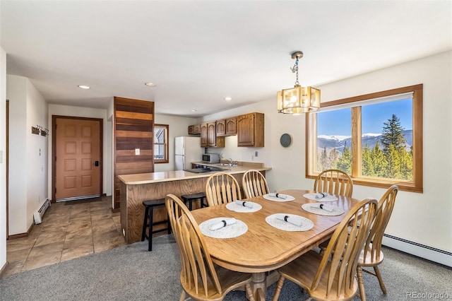 9430 Ryan Gulch Rd Unit 9450, Silverthorne, CO 80498 - dining space with baseboard heating, a chandelier, recessed lighting, and baseboards