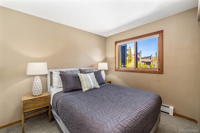 9430 Ryan Gulch Rd Unit 9450, Silverthorne, CO 80498 - bedroom with a baseboard heating unit, baseboards, and carpet flooring