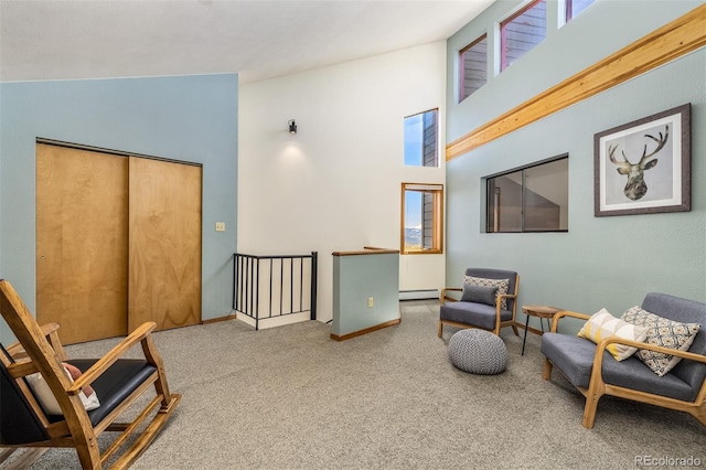 9430 Ryan Gulch Rd Unit 9450, Silverthorne, CO 80498 - sitting room with carpet, a baseboard radiator, high vaulted ceiling, an upstairs landing, and baseboards