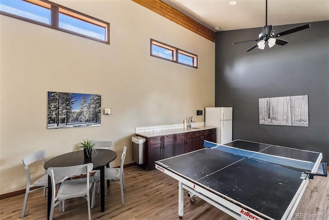 9430 Ryan Gulch Rd Unit 9450, Silverthorne, CO 80498 - recreation room with a sink, light wood finished floors, ceiling fan, baseboards, and a towering ceiling