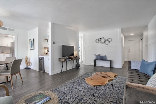 living room with beverage cooler and dark hardwood / wood-style flooring