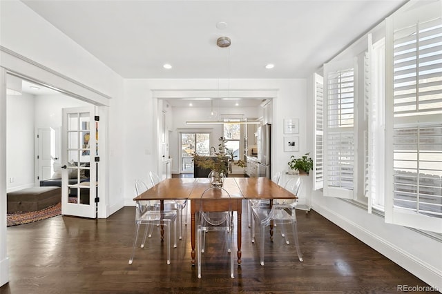 dining area with french doors and dark wood-type flooring