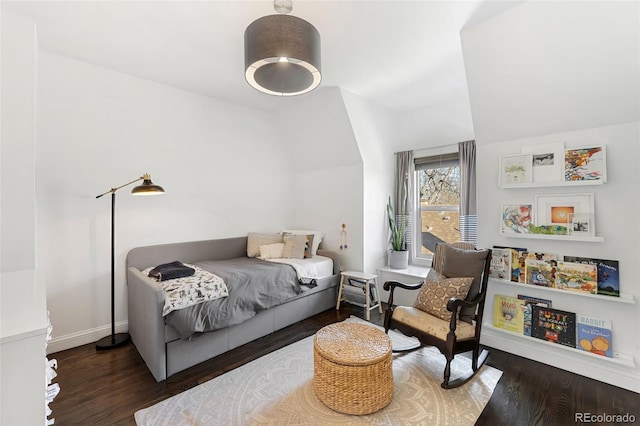 bedroom with dark hardwood / wood-style flooring