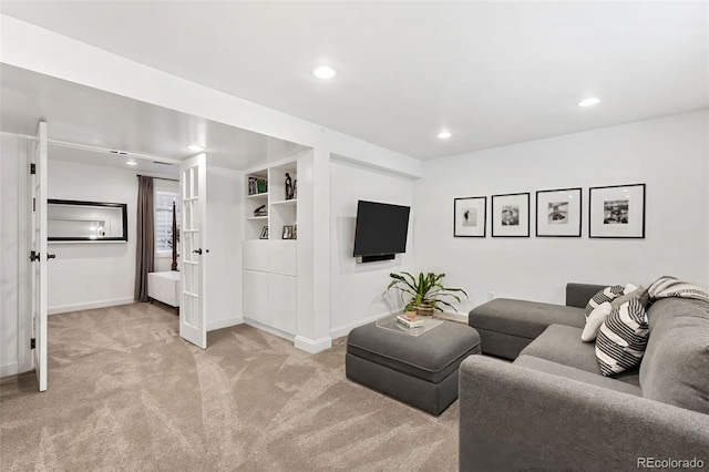 carpeted living room featuring built in shelves