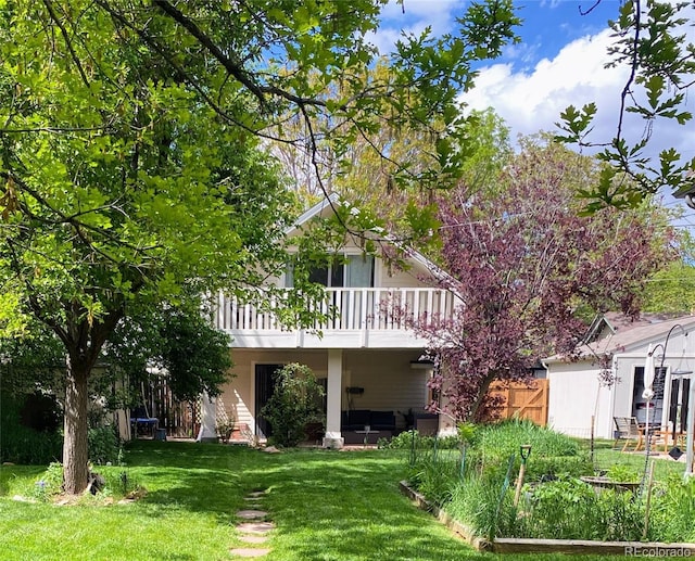 rear view of property with a yard and a deck