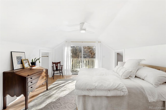 bedroom with access to exterior, light hardwood / wood-style floors, vaulted ceiling, and ceiling fan