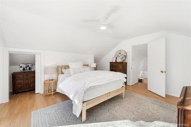 bedroom featuring hardwood / wood-style floors, ceiling fan, and vaulted ceiling