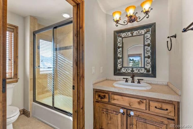 full bathroom featuring bath / shower combo with glass door, vanity, and toilet