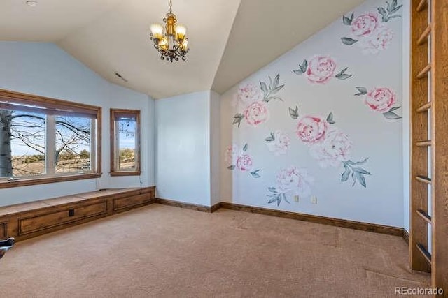 carpeted empty room with lofted ceiling and a notable chandelier