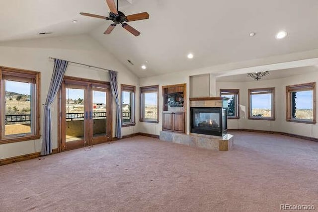 unfurnished living room featuring light carpet, a fireplace, high vaulted ceiling, and ceiling fan