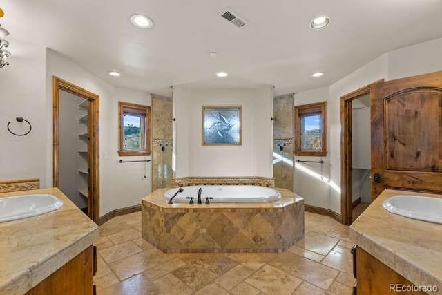 bathroom with vanity and independent shower and bath