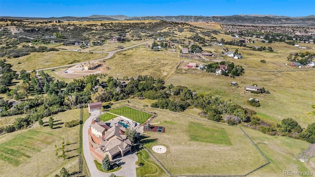 drone / aerial view featuring a mountain view and a rural view