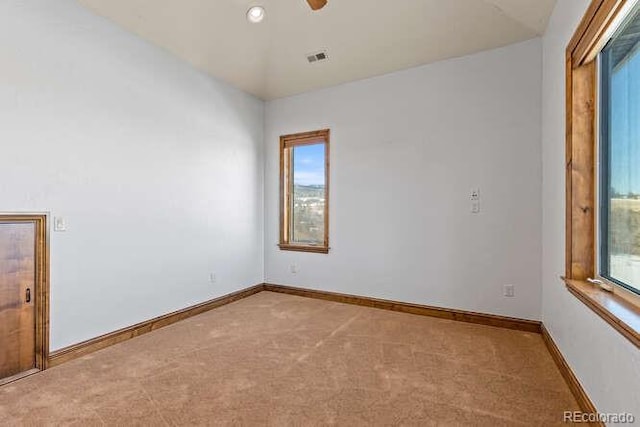 spare room featuring ceiling fan and light colored carpet