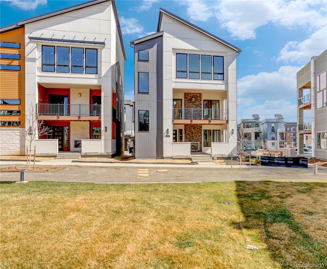 back of house with a lawn
