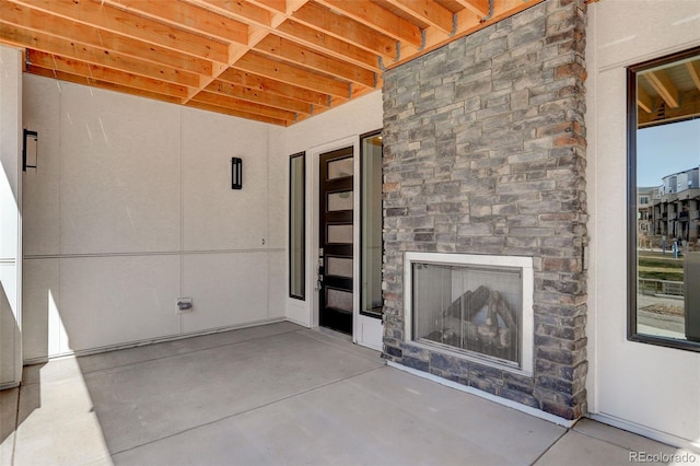 view of patio with exterior fireplace