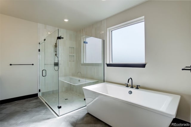 full bath with a stall shower, a freestanding tub, tile patterned flooring, baseboards, and recessed lighting