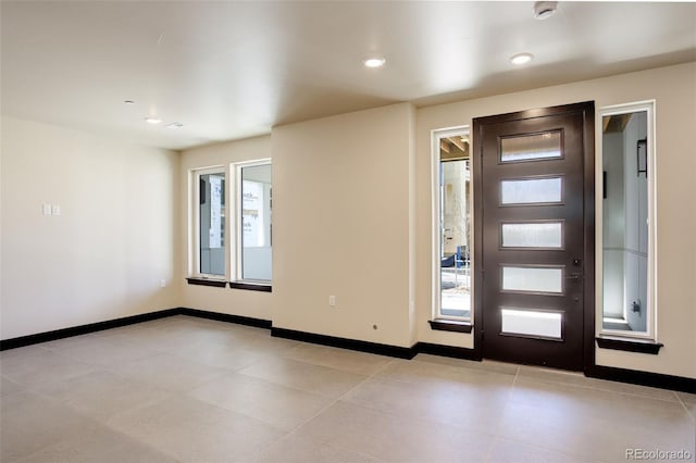 entrance foyer with baseboards and recessed lighting
