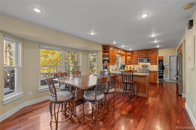 dining area featuring dark wood-type flooring