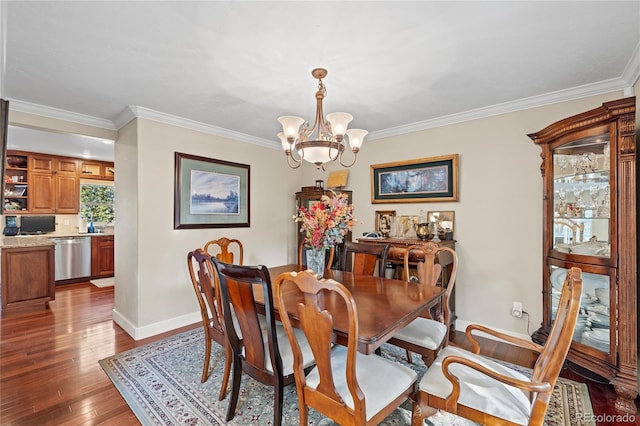 dining room with an inviting chandelier, hardwood / wood-style floors, and ornamental molding