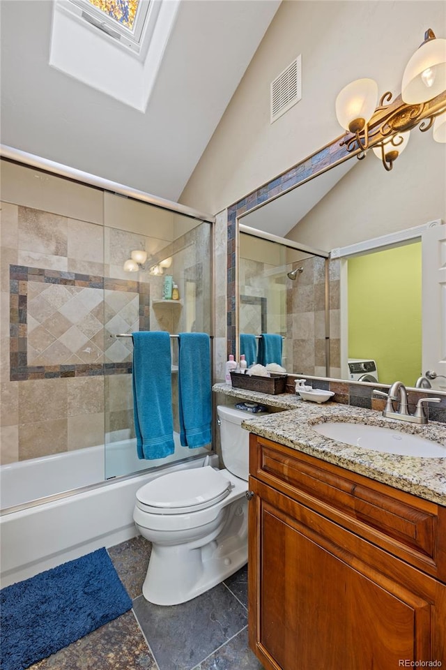 full bathroom featuring toilet, bath / shower combo with glass door, vanity, and lofted ceiling with skylight